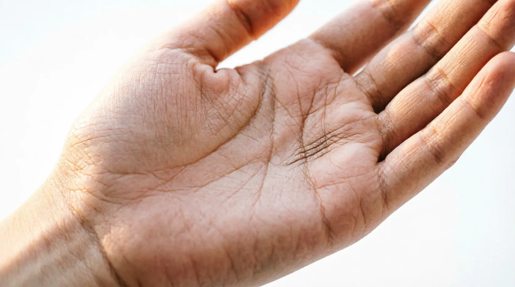 Close-up of the edge of a palm showing fine vertical lines near the pinky finger