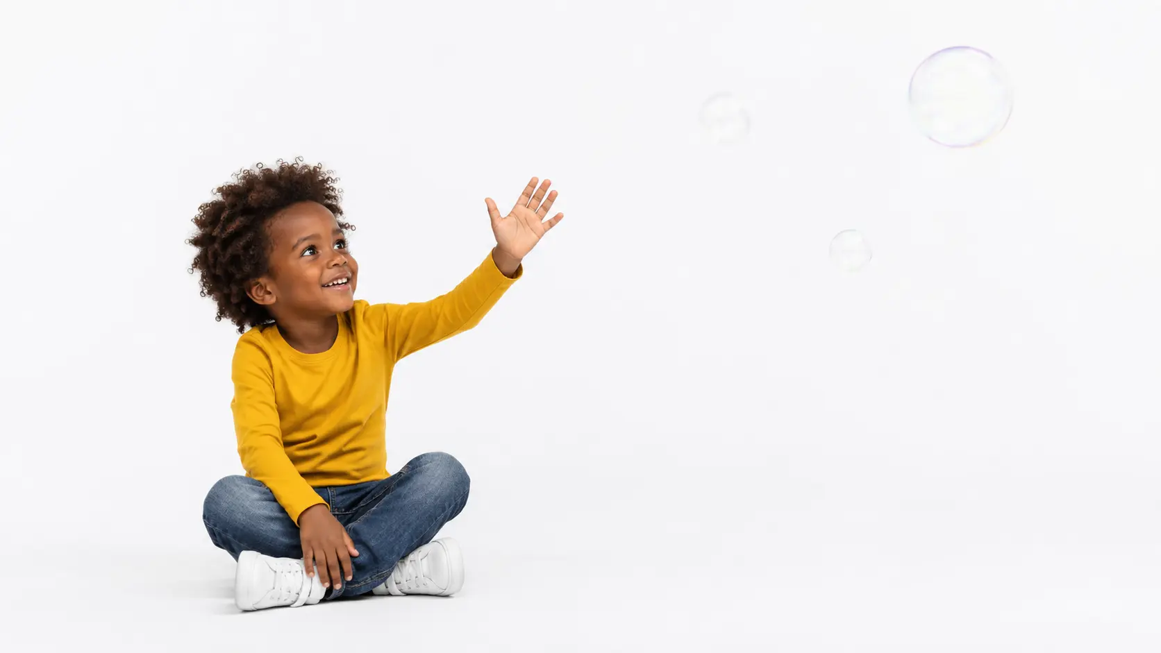 Young child playing with an invisible companion in a bright room